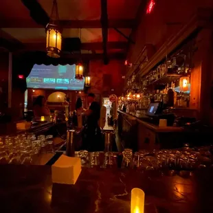 a bar with wine glasses on the bar