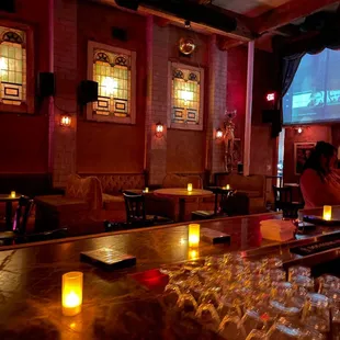 a bar with wine glasses on the bar