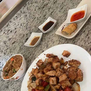 Sesame chicken, egg roll and sauces.