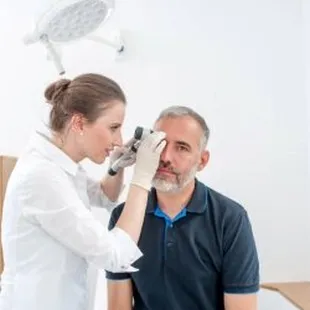 Advanced Dermatology &amp; Skin Cancer Specialists - woman doc examining man face