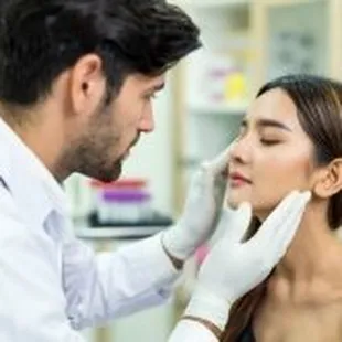 Advanced Dermatology &amp; Skin Cancer Specialists - woman being examined by male doc