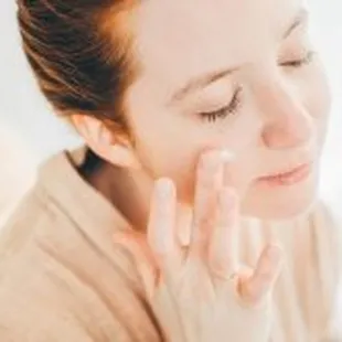 Advanced Dermatology &amp; Skin Cancer Specialists - woman eyes closed putting cream on face