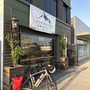 Paloma in front of Adventure Awaits Coffee Shop