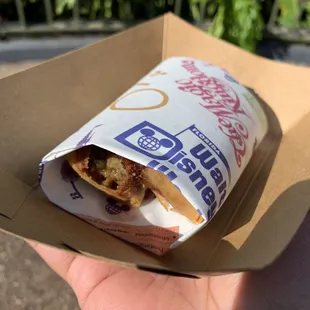 a hand holding a sandwich