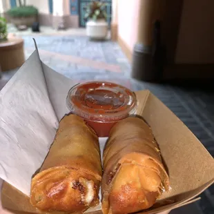 a person holding a box of food