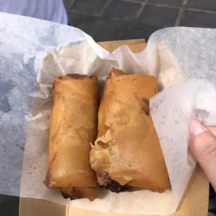 a hand holding a sandwich