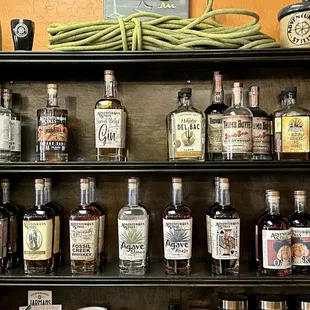 a shelf full of liquor bottles