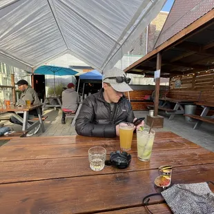 a man sitting at a table with a drink