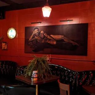 a painting of a woman on a red wall