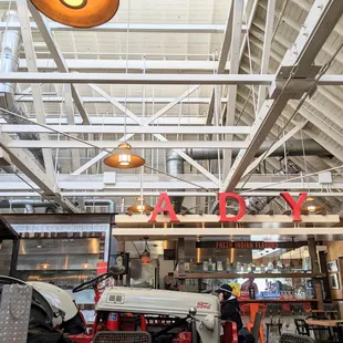 the inside of a restaurant with a tractor in the foreground