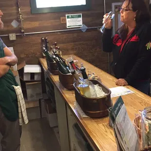 a man and a woman standing at a bar