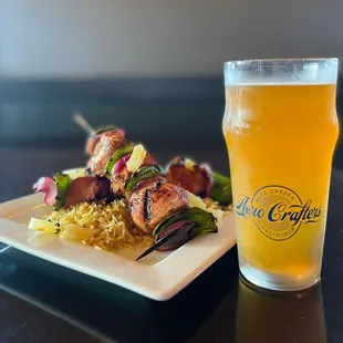 a plate of food and a glass of beer