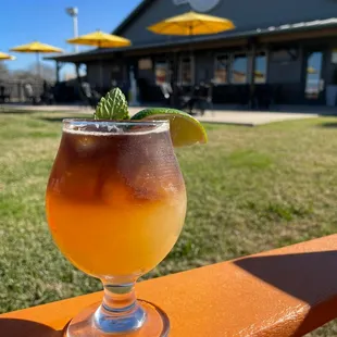 a drink in a glass with a lime garnish
