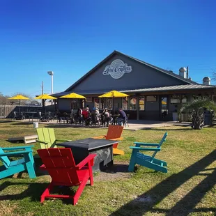 colorful chairs and tables in front of a building