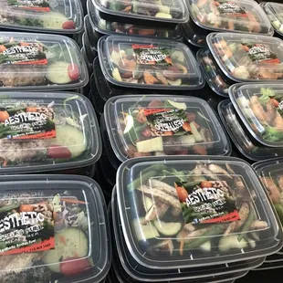 a variety of salads in plastic containers