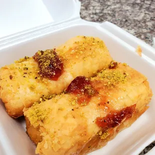 two pastries in a styrofoam container