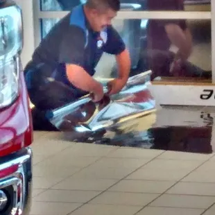 Javier getting ready to install commercial tint on store window.