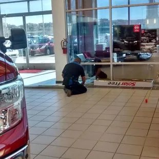 Installing tint on interior office windows.