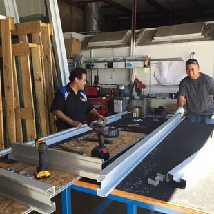 Fabricating aluminum store front frames.