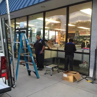 Doing the final touches to the storefront window.