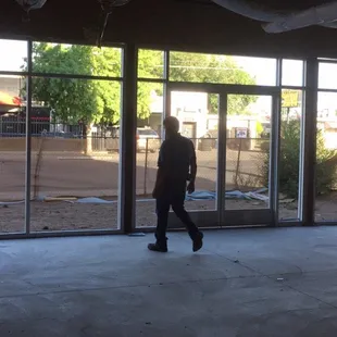 Arturo inspecting store front.