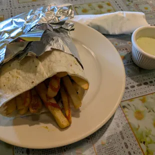 Afghan hamburger: fries, spicy ketchup, vegetables, sausages, and hard boiled eggs in a wrap. Served with chutney.