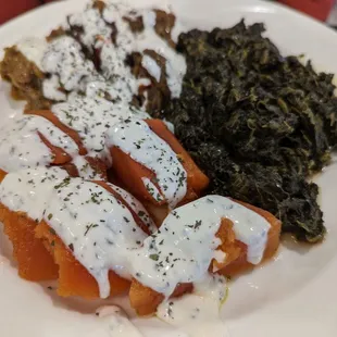 Vegetarian dish of bouranee baunjan (fried eggplant), subzi (sautéed spinach), and kadu (sautéed pumpkin).