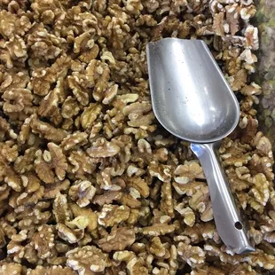 a spoon and a mixture of walnuts