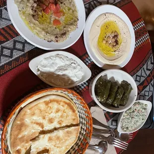 Dolmas, baba ghanouj, delicious yogurt sauce and hummus