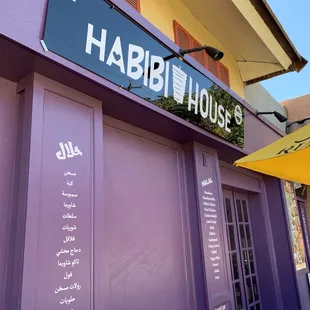 a purple building with a sign that says habibi house