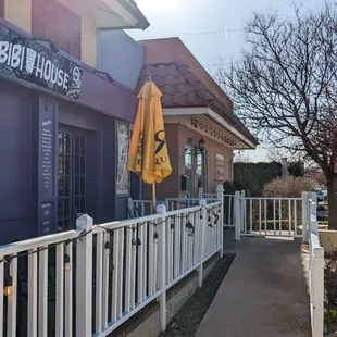 Ramp to front entrance and a garden area to the right separates the restaurant from the street