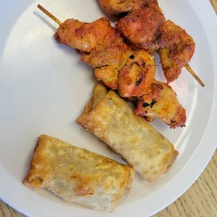 chicken skewers on a white plate