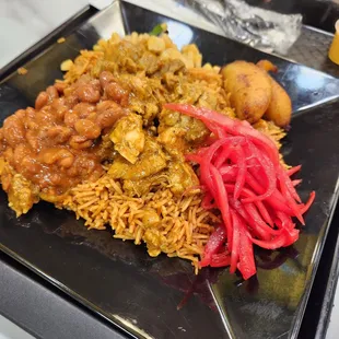 Jollof rice, chicken afra, beans, pickled onion, corn and plantains