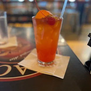 a glass of orange juice on a table