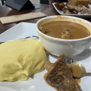 Palmnut Soup &amp; Fufu - flavorful, a bit spicy, rich and delicious. Couldn&apos;t resist pinching off some fufu before I took this pic.
