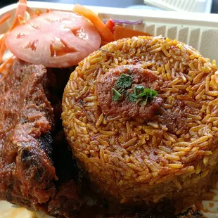 Jollof rice and fried fish with side salad. Heaven