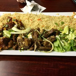 Doro wat (lamb) and kitfo (goat, center)