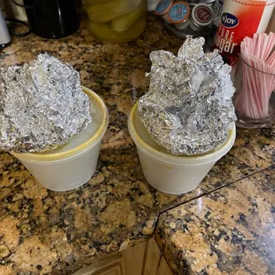two ice cream cones in plastic containers