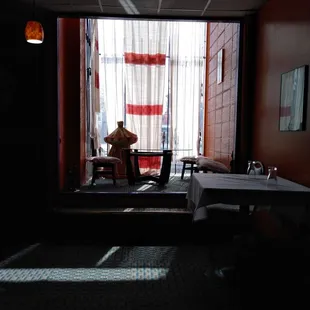 a man sitting at a table in front of a window