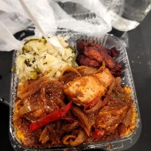 Fricassee chicken with jollof rice, cabbage and plantains.