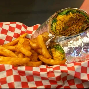 a person holding a sandwich and french fries