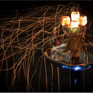 a lit candle in a glass vase