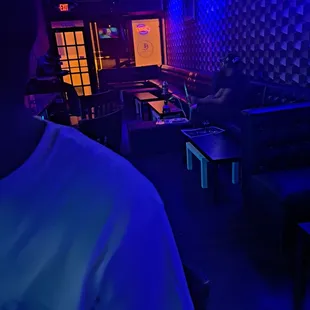 a man in a white t - shirt sitting at a table