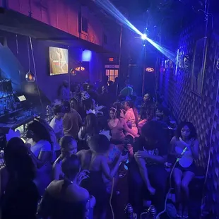 a group of people sitting around a bar