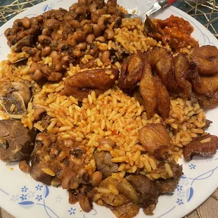 Goat curry with jolof rice,plantains and beans