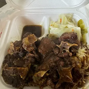 Oxtails over rice and peas and cabbage