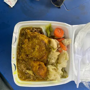 Curry Chicken, cabbage, vegetables, rice and peas.