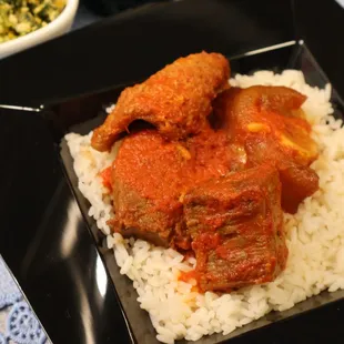 a plate of food with rice and meat