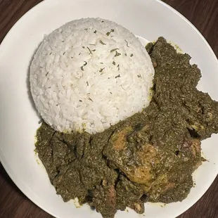 a plate of food with rice and meat