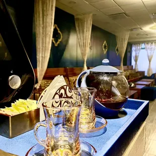 a teapot and glasses on a tray